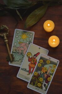 Mystical tarot card reading setup with candles and an antique key.