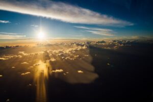 Stunning aerial view of sunrays piercing through clouds during golden hour over Cuba.